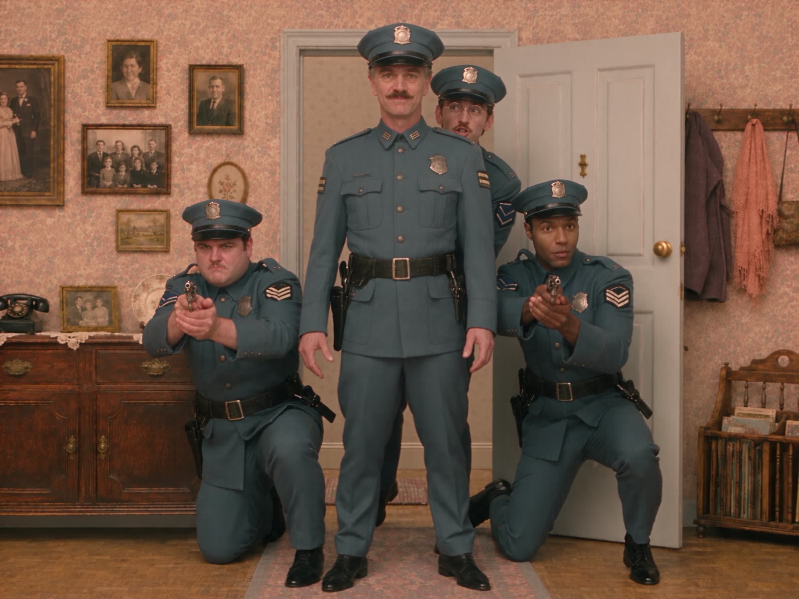 Still from Wrong Apartment: four officers stacked in formation, weapons drawn
